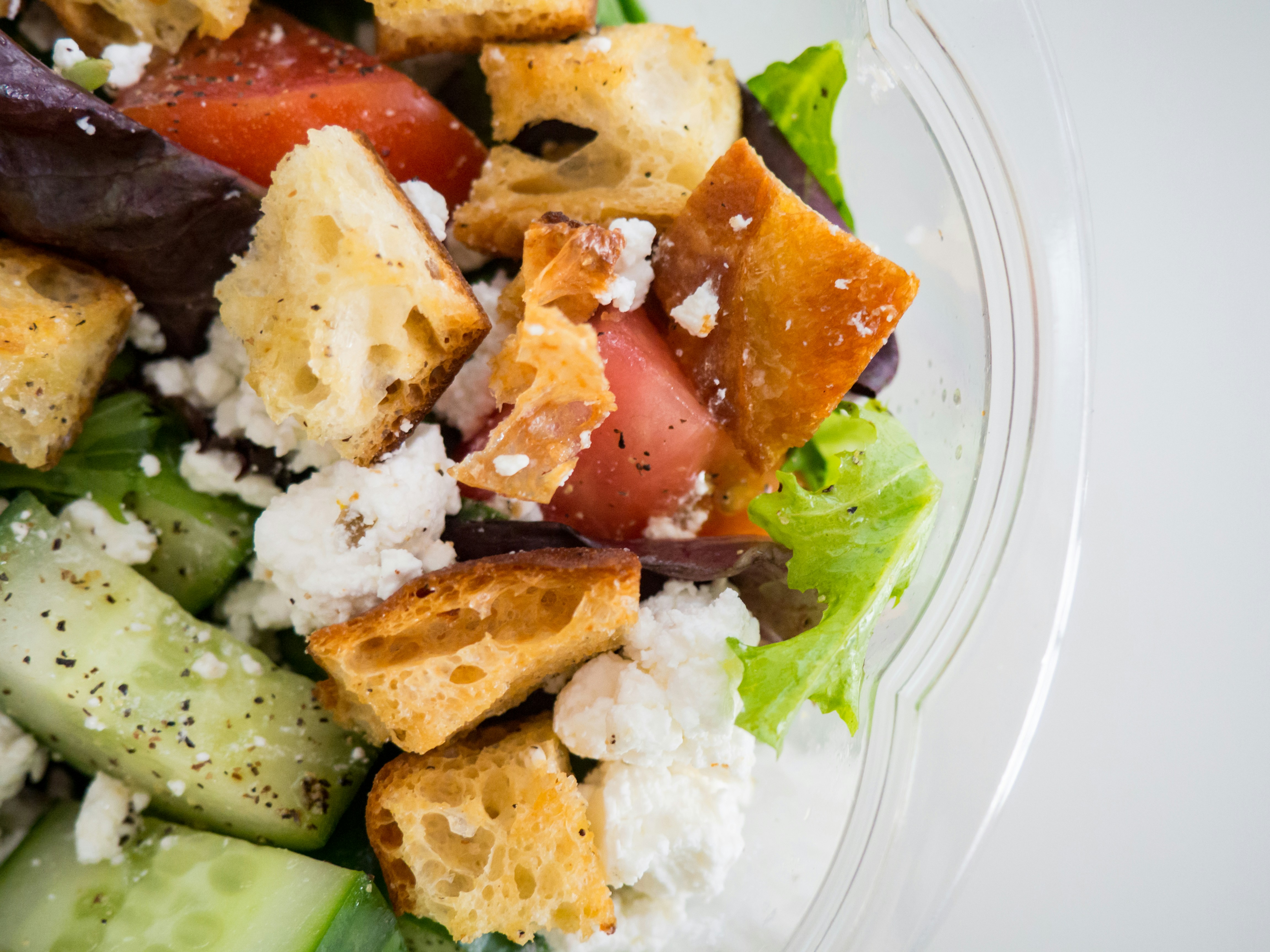 A bowl of homemade potato salad with creamy dressing and fresh herbs.