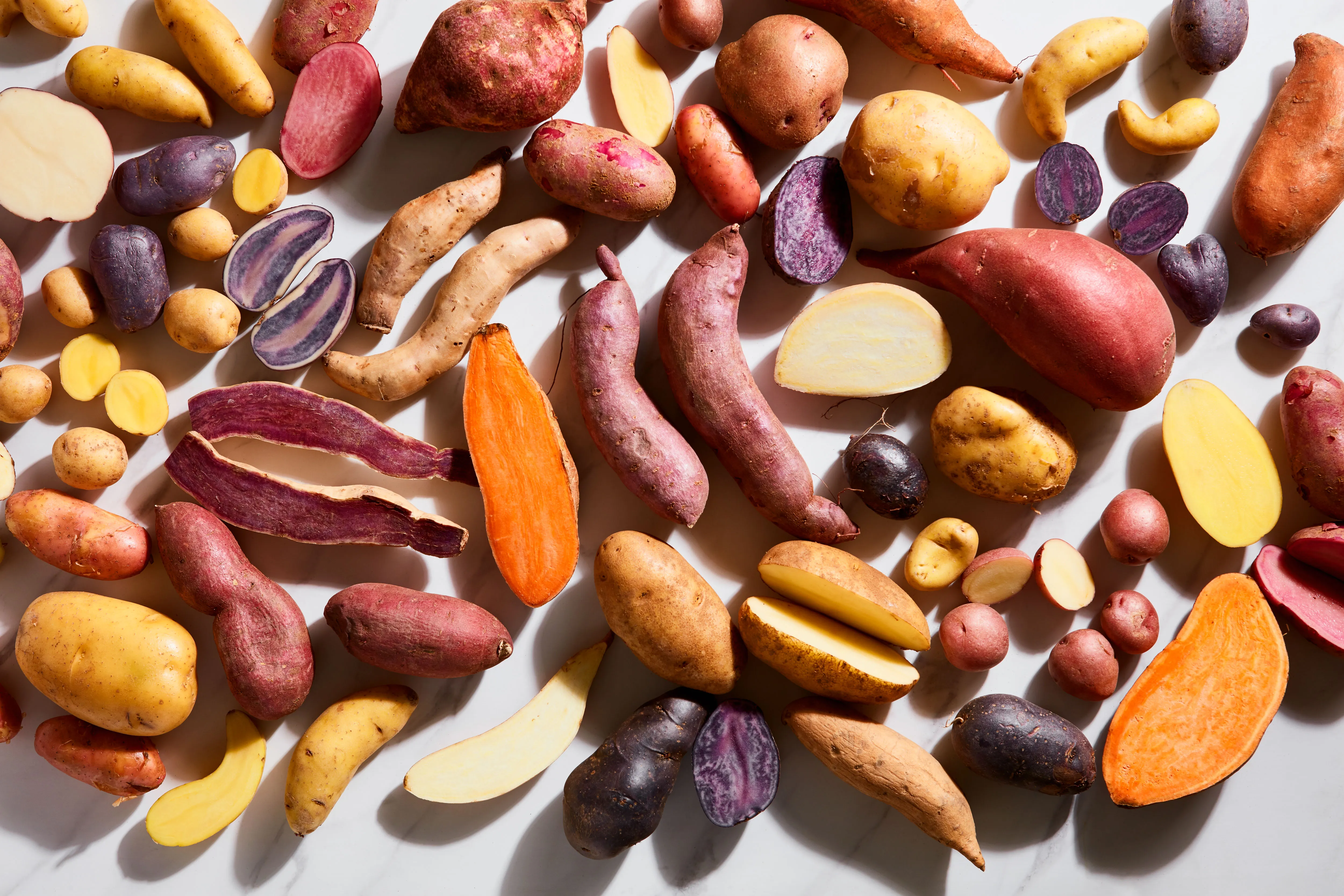 An assortment of potato varieties with different colors and textures, ideal for various cooking styles.